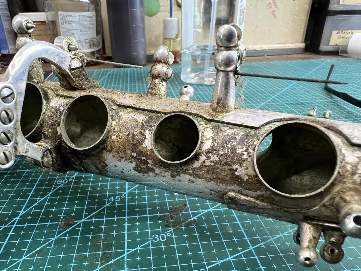 Silver-plated saxophone body, heavy grime and corrosion