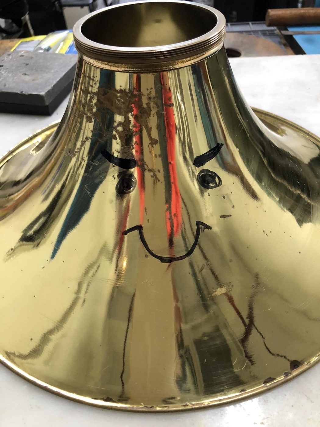 The same French horn bell after dent repair