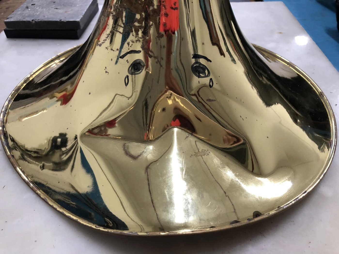 French horn bell badly crushed before repair